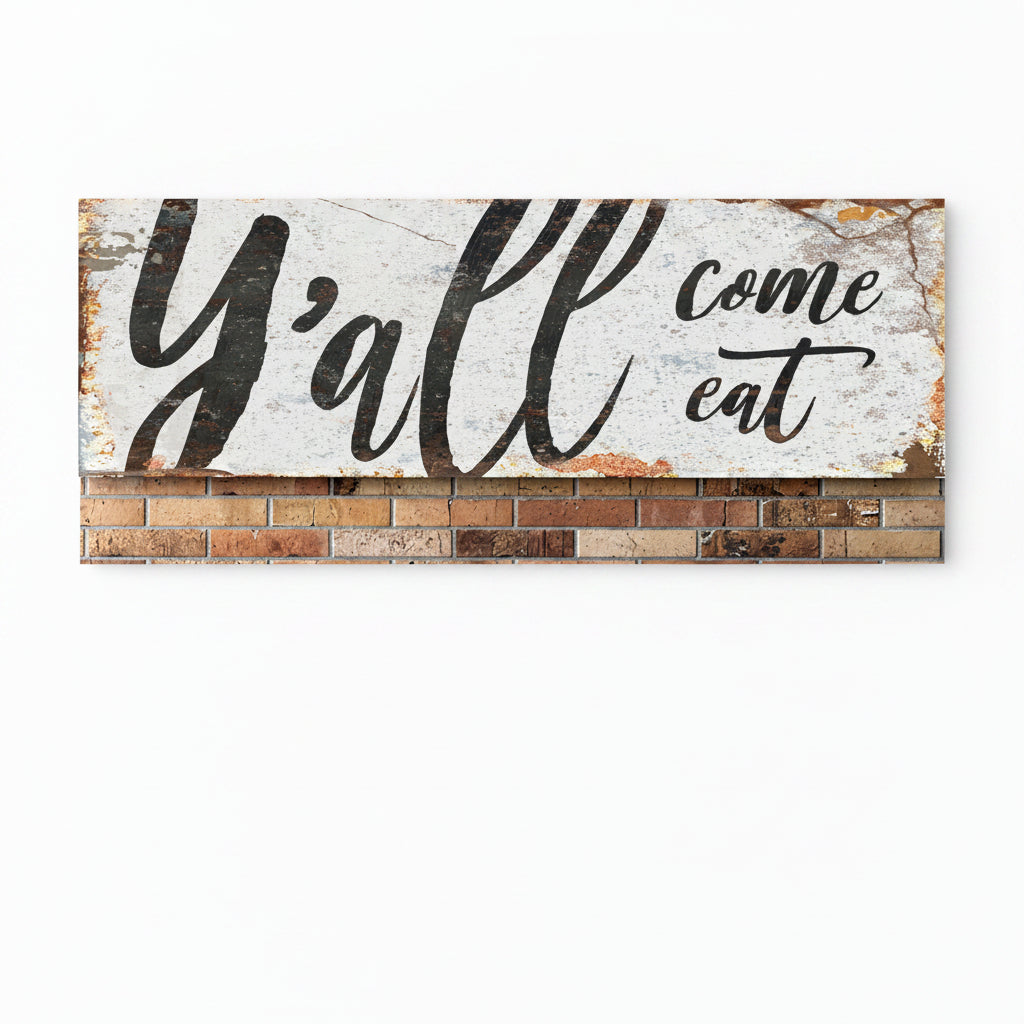 Rustic kitchen wall sign with distressed “Y’all come eat” script in black on white