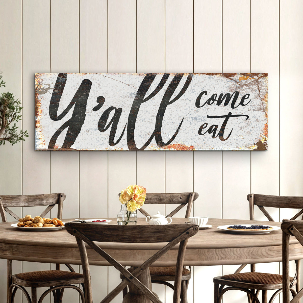 Landscape kitchen wall sign with distressed white background and black “Y’all come eat” text